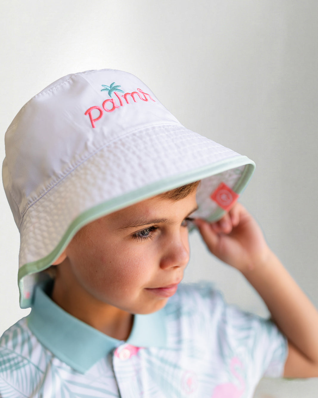 White bucket hat with a "Palmr" logo in embroidery