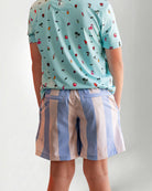 Person wearing striped shorts with "Palmr" embroidery