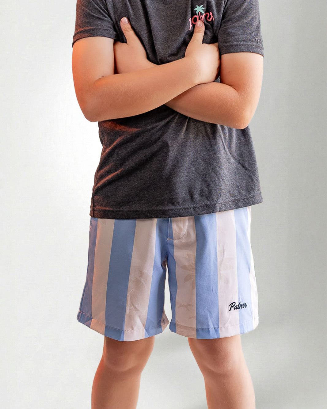 Person wearing striped shorts with "Palmr" embroidery