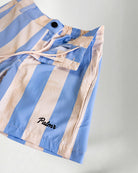 Person wearing striped shorts with "Palmr" embroidery