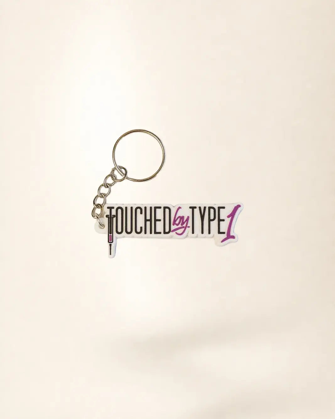 Keychain with 'Touched by Type 1' text on a light background