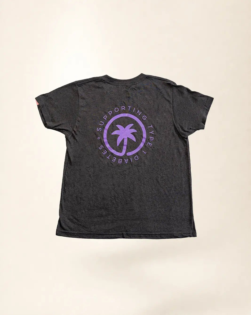 Black t-shirt with purple palm tree design and text on a beige background