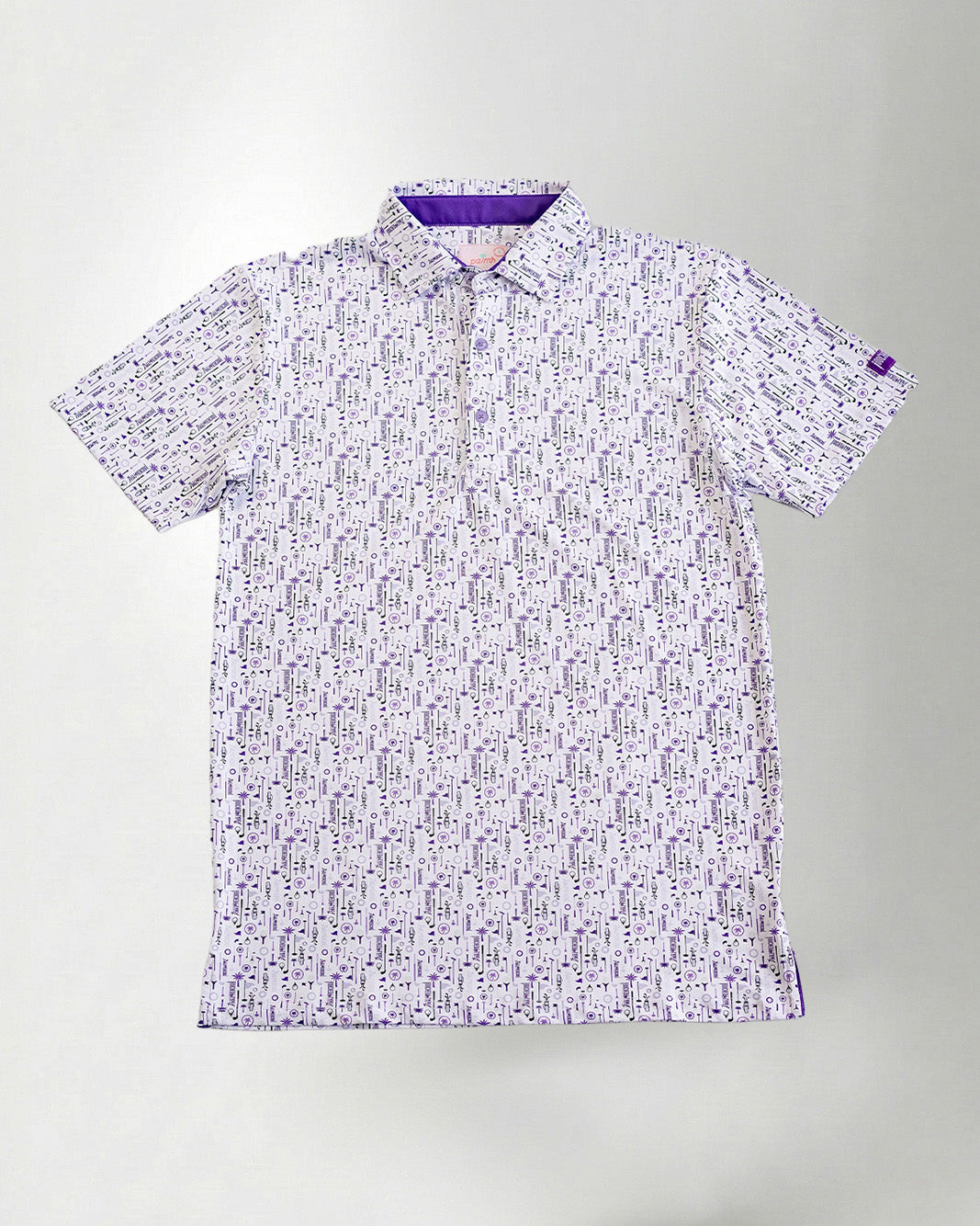 Man wearing a patterned shirt and cap against a plain background