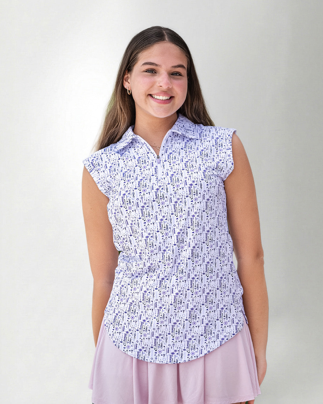 Woman wearing a patterned sleeveless polo and a skirt