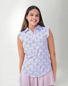 Woman wearing a patterned sleeveless polo and a skirt