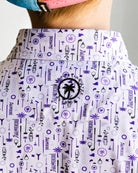 Child wearing a patterned shirt and blue cap against a plain background