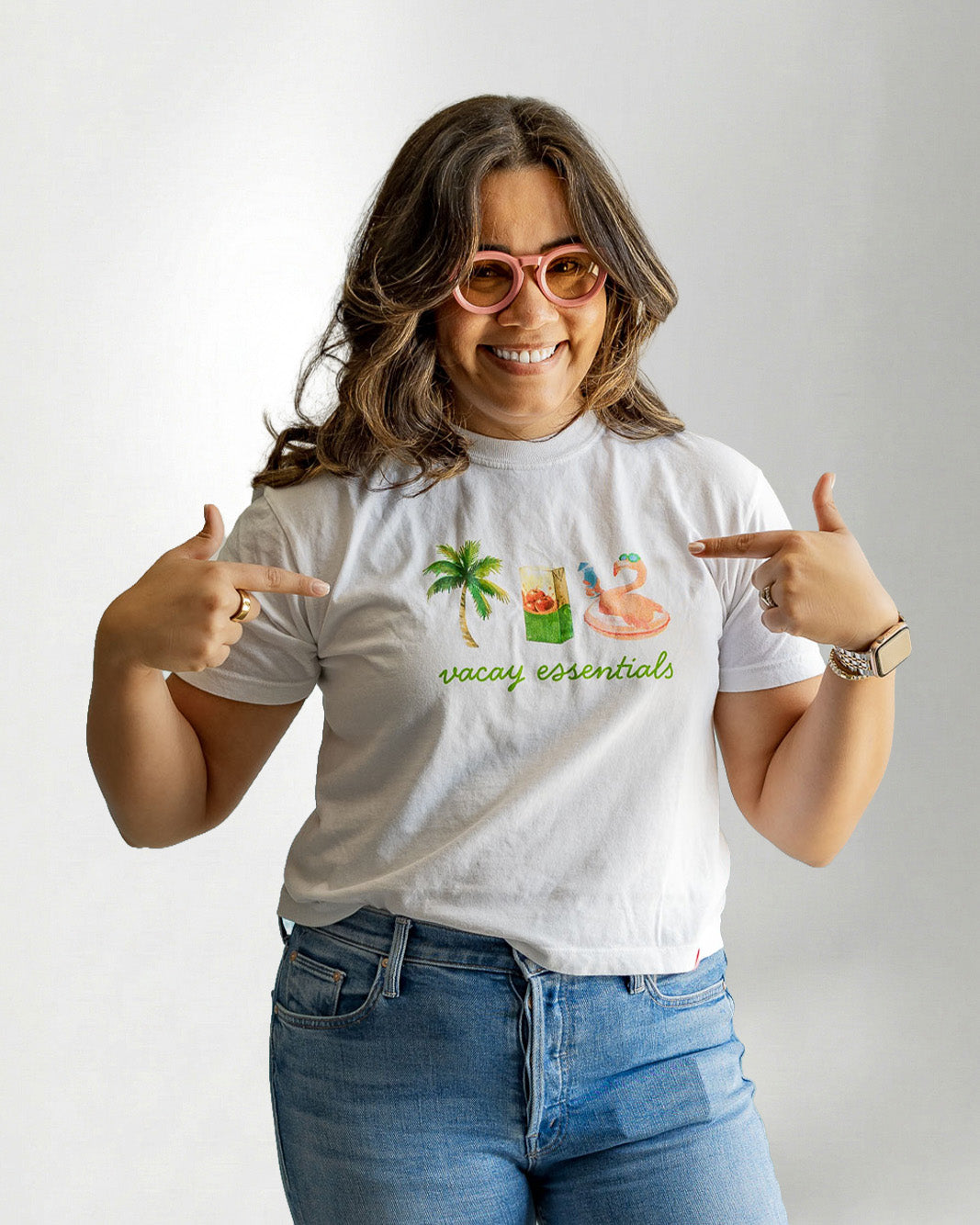 Woman wearing a white tee showcasing a "Palmr" branding with vacay essentials objects.