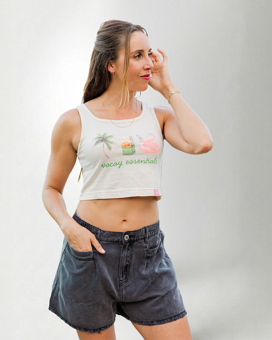 Woman wearing a white tank top with a a palm, juice and float.