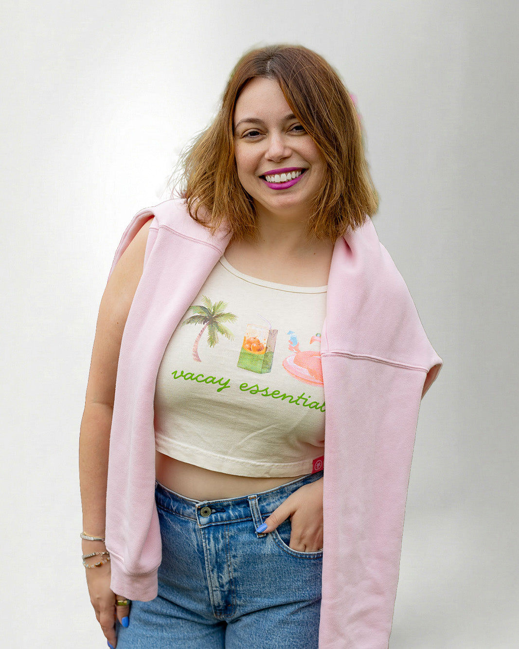 Woman wearing a white tank top with a a palm, juice and float.