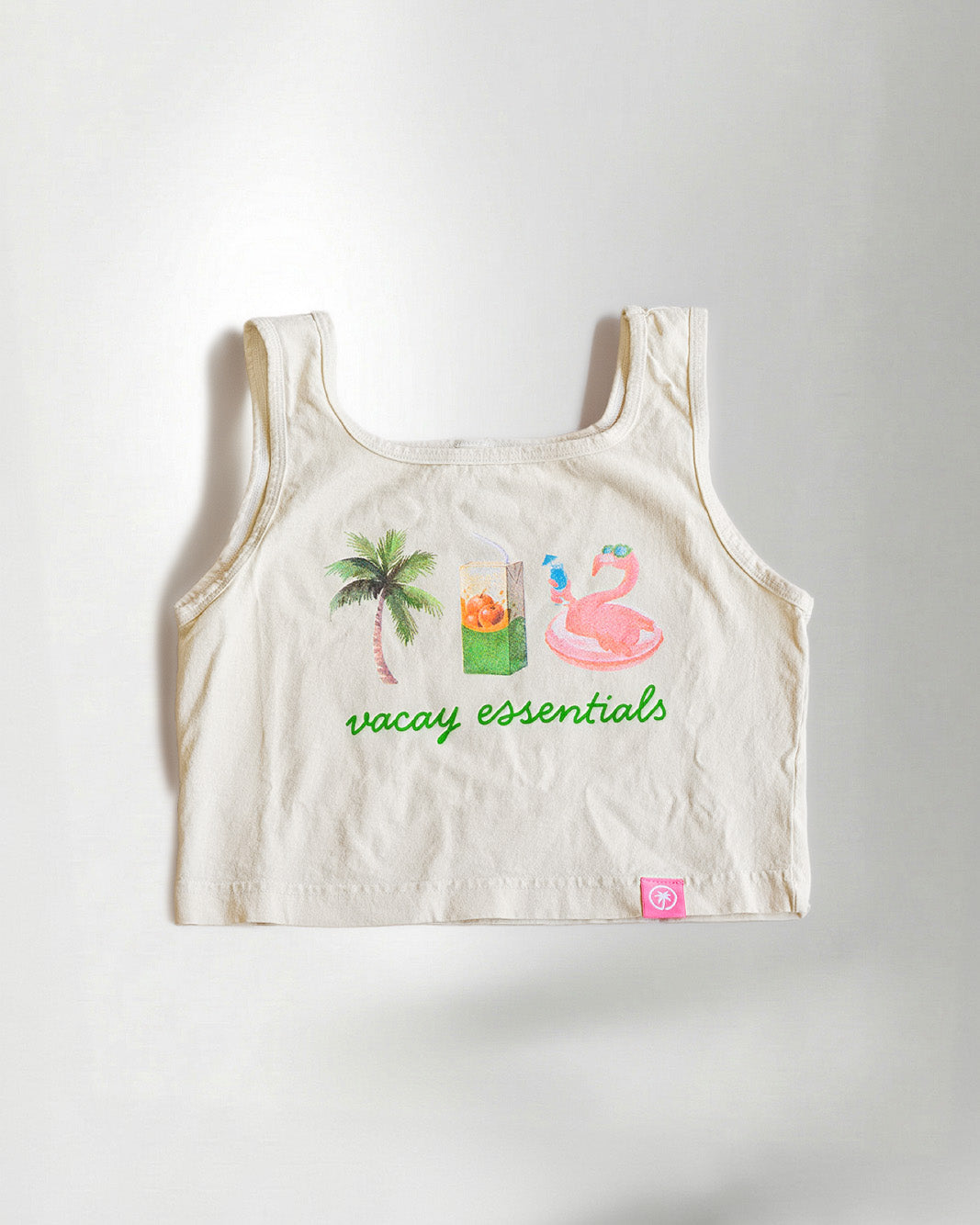 Woman wearing a white tank top with a a palm, juice and float.