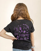 Person wearing a black t-shirt with purple graphics and text on the back