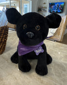 Basal Dog Plush, a black Labrador plush wearing a purple Touched By Type 1 bandana and a Basal name tag