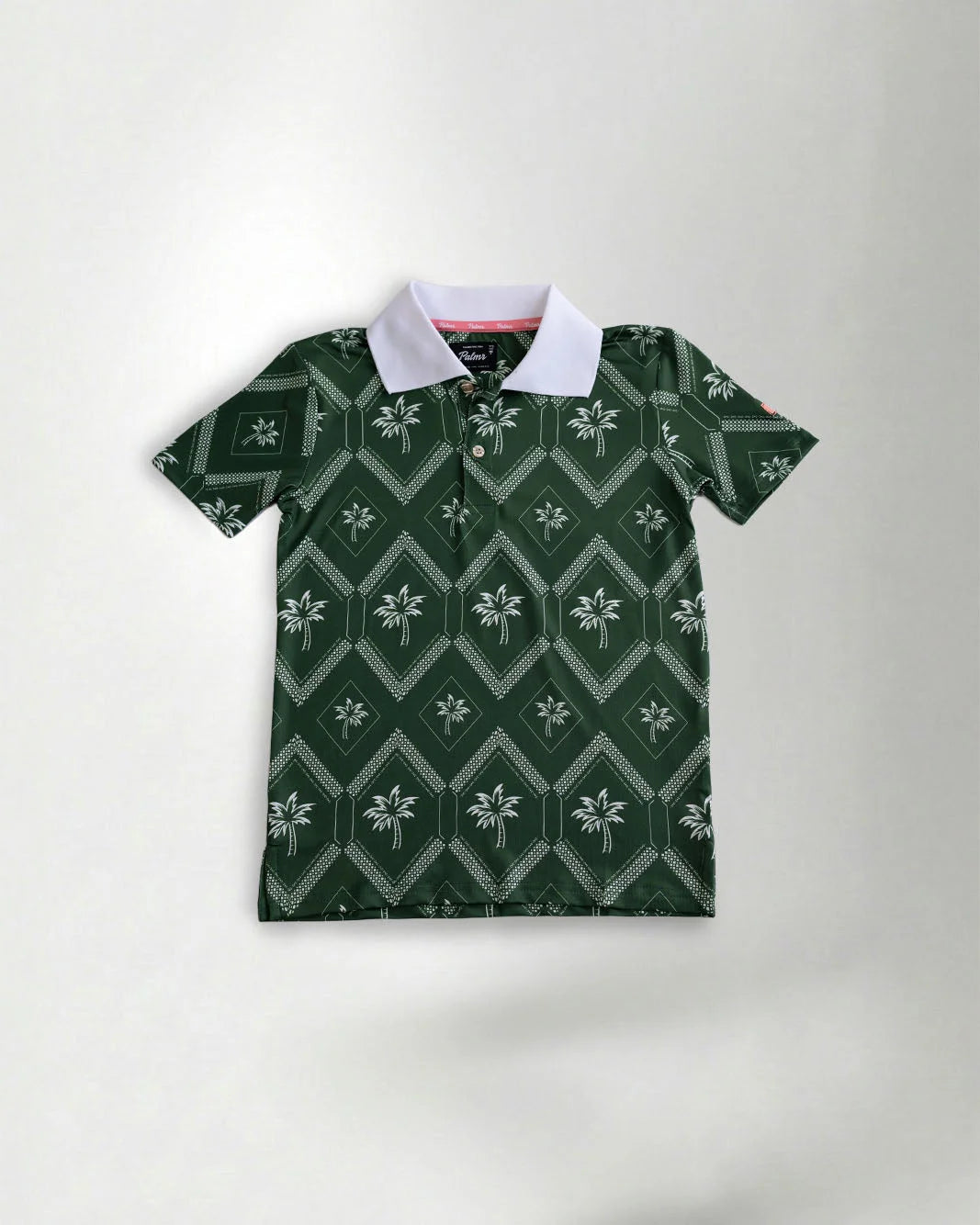 Green polo shirt with contrasting white neck showcasing a palm pattern against a grey background
