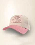 A baseball cap with a light beige front panel and a pink brim, featuring pink embroidered text on the front that reads 'Dakler Style Four Oh Seven Orlando 26'.