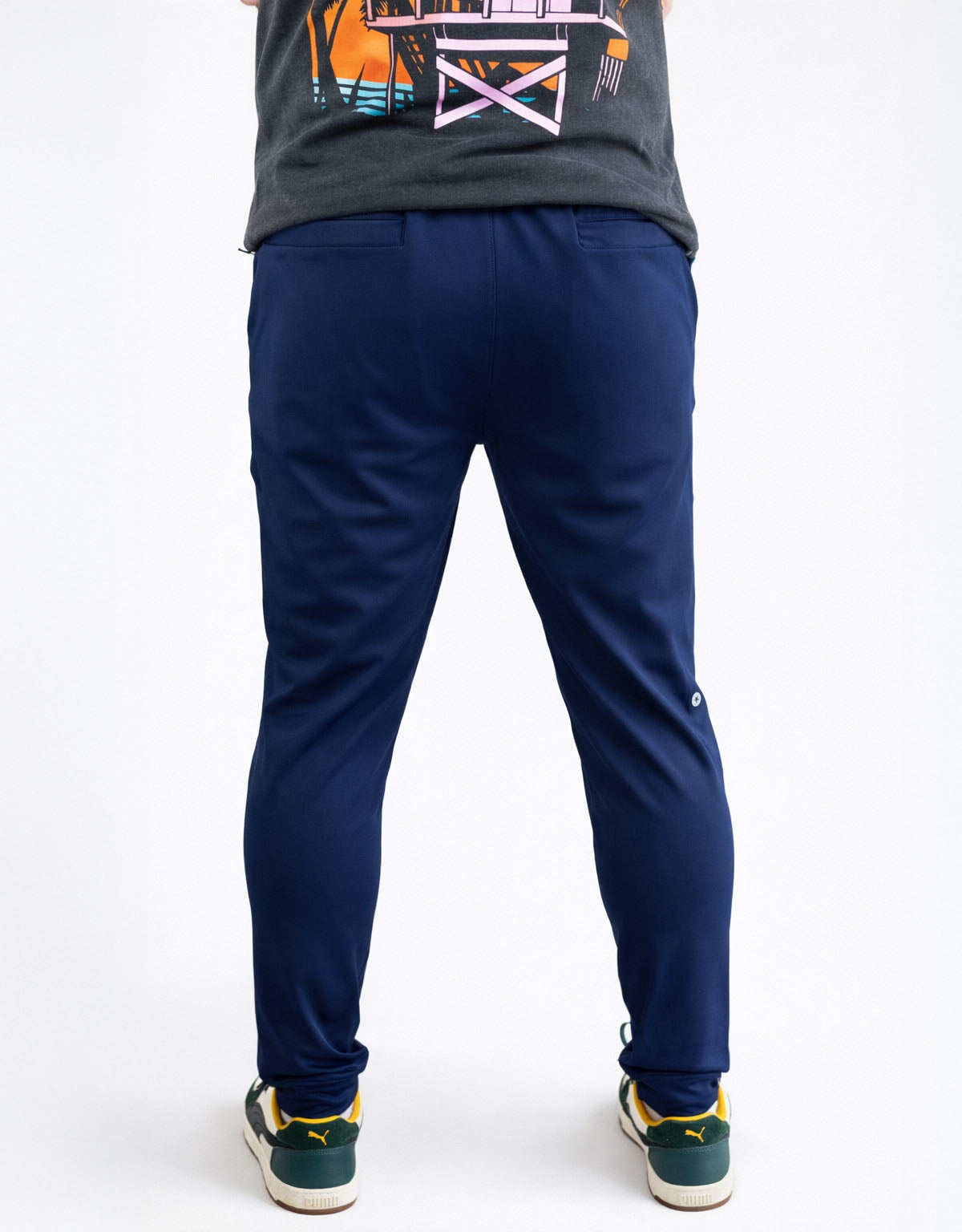 Person wearing navy blue pants on a white background
