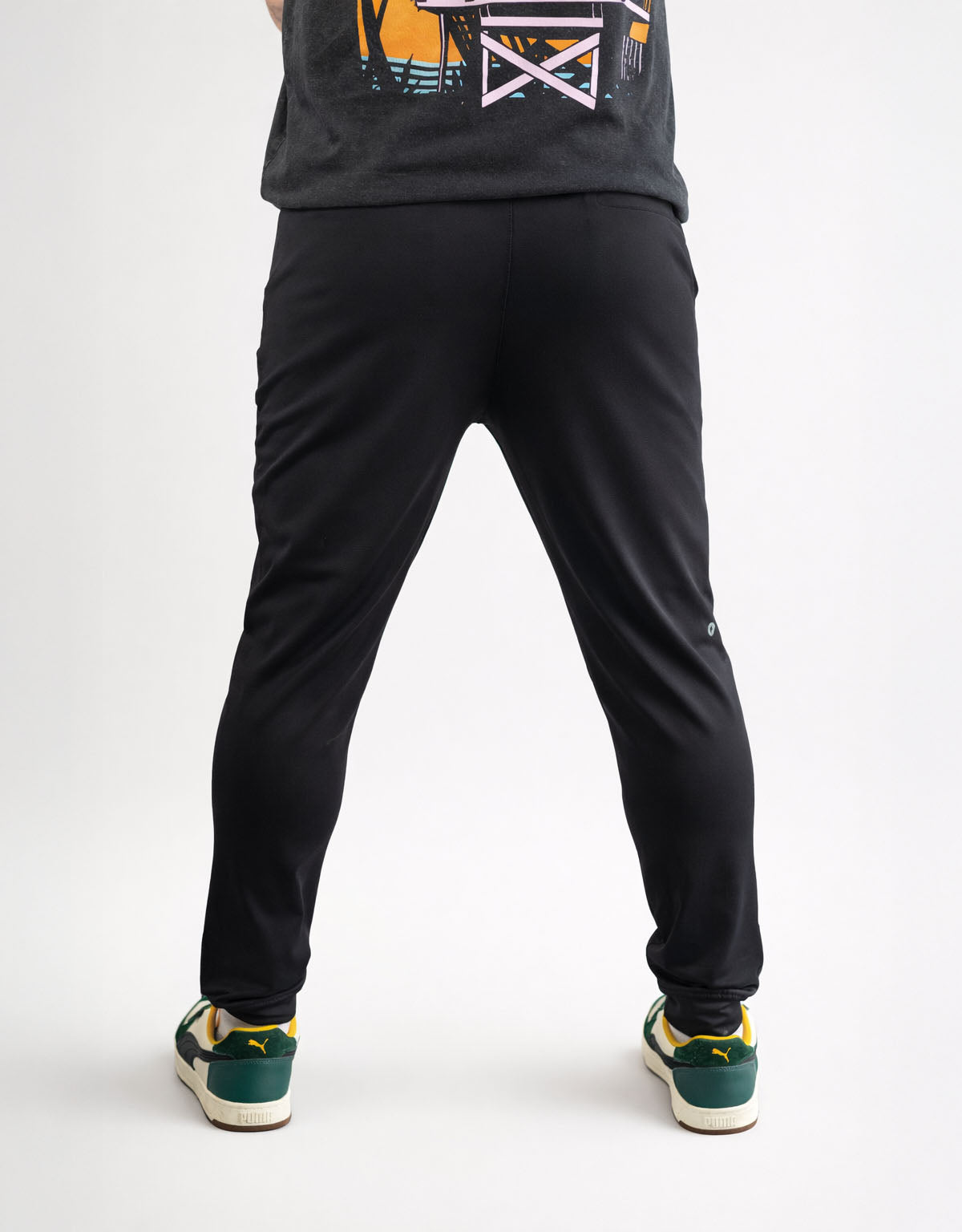 Person wearing black pants and a dark shirt on a white background