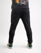 Person wearing black pants and a dark shirt on a white background