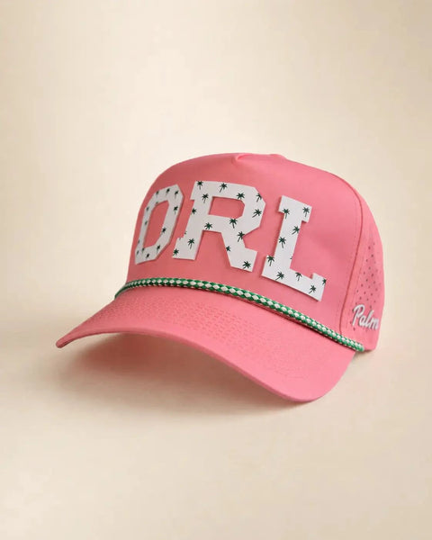 The ORL Signature Hat (Pink): pink rope snapback with ORL in white palm-print letters, green and white rope on the brim, Palmr script on the side.