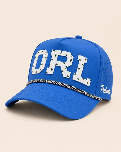 The ORL Signature Hat (Blue): royal blue rope snapback, white ORL with small green palm trees, black and white braided rope, perforated sides.