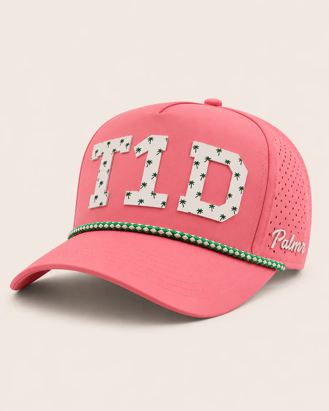 Pink cap with 'T1D' and palm tree design on a beige background
