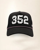 The 352 Signature Hat (Black), front view: white raised 352 with small palm print on a black crown, pink and white rope along the brim.