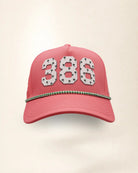 The 386 Signature Hat (Pink), front view: white raised 386 with small palm print on a pink crown, green and white rope along the brim.