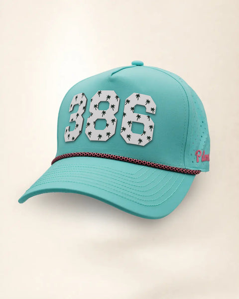 The 386 Signature Hat (Teal), three-quarter view: white raised 386 with small palm print on a teal rope snapback, pink and black rope, pink Palmr script.