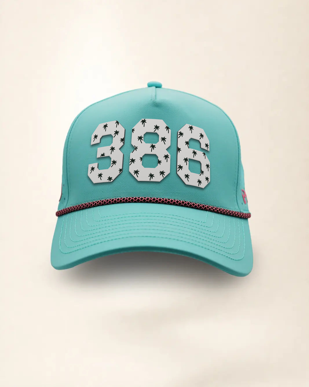 The 386 Signature Hat (Teal), front view: white raised 386 with small palm print on a teal crown, pink and black rope along the brim.