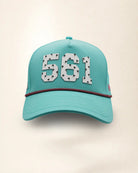 The 561 Signature Hat (Teal), front view: white raised 561 with small palm print on a teal crown, pink and black rope along the brim.