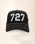 The 727 Signature Hat (Black), front view: white raised 727 with small palm print on a black crown, pink and white rope along the brim.