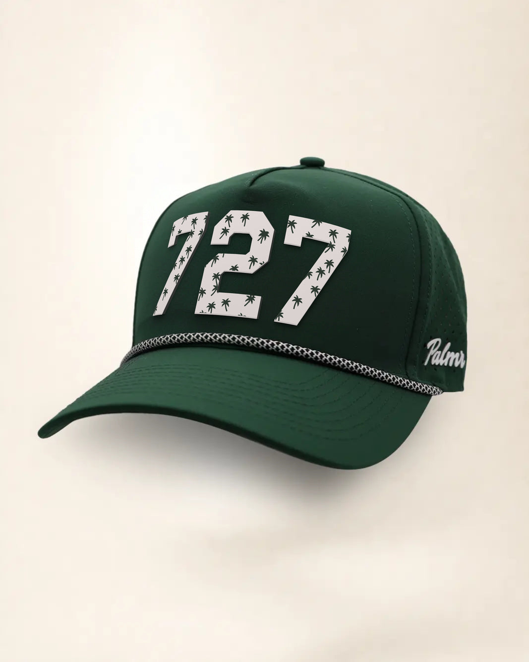 The 727 Signature Hat (Green), three-quarter view: white raised 727 with small palm print on a green rope snapback, black and white rope, white Palmr script.