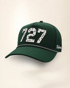 The 727 Signature Hat (Green), three-quarter view: white raised 727 with small palm print on a green rope snapback, black and white rope, white Palmr script.