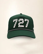 The 727 Signature Hat (Green), front view: white raised 727 with small palm print on a green crown, black and white rope along the brim.