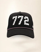 The 772 Signature Hat (Black), front view: white raised 772 with small palm print on a black crown, pink and white rope along the brim.
