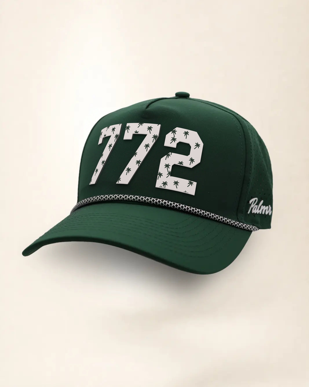 The 772 Signature Hat (Green), three-quarter view: white raised 772 with small palm print on a green rope snapback, black and white rope, white Palmr script.