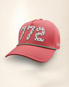 The 772 Signature Hat (Pink), three-quarter view: white raised 772 with small palm print on a pink rope snapback, green and white rope, white Palmr script.