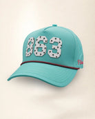 The 863 Signature Hat (Teal), three-quarter view: white raised 863 with small palm print on a teal rope snapback, pink and black rope, pink Palmr script.