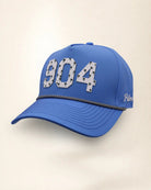 The 904 Signature Hat (Blue), three-quarter view: white raised 904 with small palm print on a blue rope snapback, black and white rope, white Palmr script.