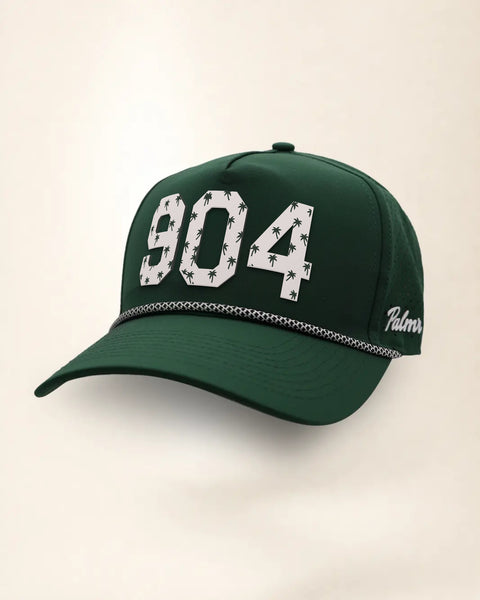 The 904 Signature Hat (Green), three-quarter view: white raised 904 with small palm print on a green rope snapback, black and white rope, white Palmr script.