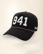 The 941 Signature Hat (Black), three-quarter view: white raised 941 with small palm print on a black rope snapback, pink and white rope, white Palmr script.