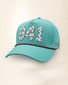 The 941 Signature Hat (Teal), three-quarter view: white raised 941 with small palm print on a teal rope snapback, pink and black rope, pink Palmr script.